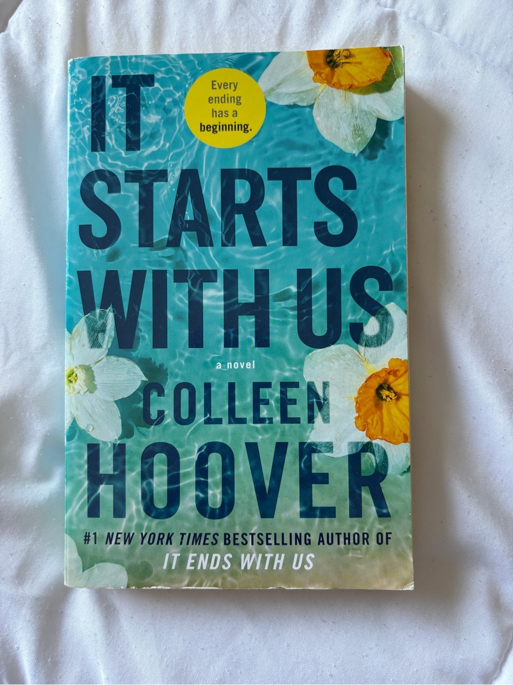 It Starts with Us by Colleen Hoover, paperback.